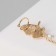 Earring "Kaff" butterfly in flight, white-pink color in gold