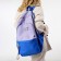 A backpack with a zipper, 4 outer pockets, lilac color/blue color