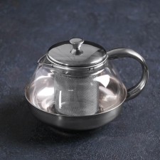 A glass teapot with a metallic sieve 