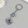 Keychain from the evil eye Metal "petal" 3x3.5 cm