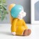 Souvenir Polystone "Baby in a yellow dress with earrings" 6x9.2x5.5cm