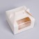 The box is folding, with a window and a handle, white, 16 x 16 x 9 cm