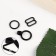 A set of metal fittings for a bow tie: ring, hook, regulator 1 cm, black color