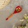 A spoon of wooden "rubella", a half -bacon, a red background