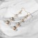 Hanging earrings with rhinestones "Drop" path, white color in gold, 6.2 cm