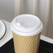 A plastic disposable lid for a white glass, with a valve, d = 9 cm