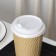 A plastic disposable lid for a white glass, with a valve, d = 9 cm