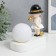 Souvenir Polystone Light "Baby in a black hat, with a gold bubble at the ball" 16.5x8x16 cm