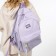 A backpack with a zipper, 4 outer pockets, lilac color