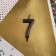 Candle for the cake, number "7", black.