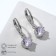 Earrings with bloom rhinestones hanging, white color in silver