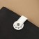 The fastener is sewn for a bag, on a button, made of genuine leather, 13.5 × 2.5 cm, white/silver color