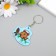EVA keychain "Squirrel in headphones on a spruce branch with cones" 5x5 cm