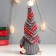 Interior doll "Santa Claus with ski sticks, a gray cap with patterns" 27x12x8 cm