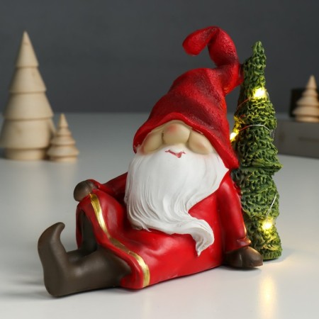 Souvenir Polystone Light "Santa Claus in a red outfit sits at the Christmas tree" 14x7x18 cm