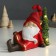 Souvenir Polystone Light "Santa Claus in a red outfit sits at the Christmas tree" 14x7x18 cm