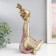 Polystone souvenir "Baby with two tails" gold with pink 21x13.5x26 cm