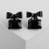 Earrings with a ostric "bow" with a rectangle, the color is black