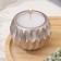 Candle "Shar" in a candlestick with sharp faces of gypsum, 7x6cm, champagne