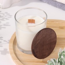 A candle made of soy wax in a glass with a wooden wick and a vanilla cappuccino lid, 110 g