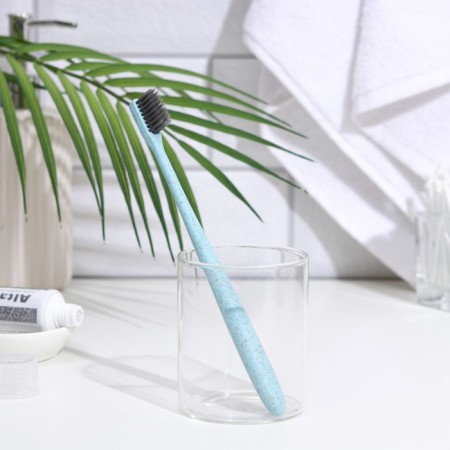 The toothbrush is soft, in the tube, turquoise