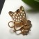 Brooch "Cat" with a fish, the color is white in gold