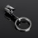 Cartage keychain, piston, metal, black