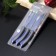 A set of kitchen utensils FADED, 3 objects: 2 knives, fork for meat, blue color