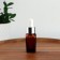 A glass bottle for storage with a pipette, 10 ml, brown/white color