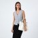 The bag is female, medium size, long belt, white color