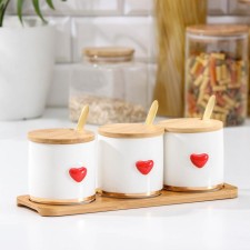 A set of ceramic cans for bulk products with spoons on the wooden stand “Estet. Hearts 