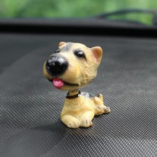 Dog on a car panel shocking his head, Irish Terrier