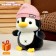 Soft toy "Penguin" with a backpack, in a pink hat, 22 cm
