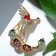 Brooch "Firebird with a magic tail", colored in gold