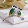 Brooch "Owls" on a flower branch, white-green color in silver