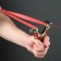 Metal slingshot with a laser target designator, compass