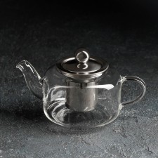 A glass teapot with a metal sieve 