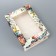 The box is folding, the lid is “the most beautiful”, 21 x 15 x 7 cm with a window