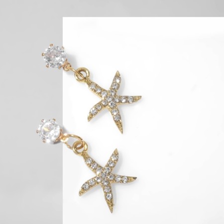 Earrings with rhinestones "Sea star", white color in gold-1