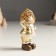 Polystone souvenir "Baby in a gold caftan and cap, with a bird/gift" Mix 4x5x10 cm 94988