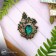Brooch "openwork", emerald color in black gold