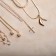 Piece "Chain" thread of pearls, a smooth cross, white color in gold, 35 cm