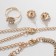 Set 4 objects: earrings, necklaces, bracelet, ring "grace" circles, white color in gold