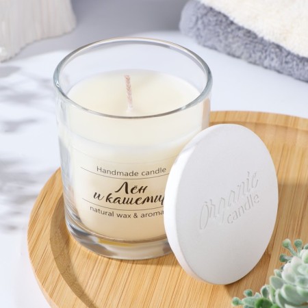 A candle in a glass flavored "linen and cashmere", 7x7 cm, 27 hours