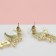 Earrings with “crescent” rhinestones, the color is white in gold