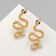 New Year! Symbol of the year 2025! Earrings with rhinestones "snake" aesthetics, white color in gold