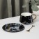 Tea couple ceramic with a gold spoon, 2 items: a cup 240 ml, a saucer d = 14.8 cm, black color is black