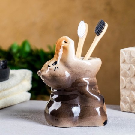 A glass under the toothbrush "Hippo"