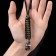 A keychain is a label for a “plague doctor” knife from a paracord, black and green