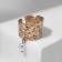 Ring "crumpled lines" with bead, white color in gold, dimensionless